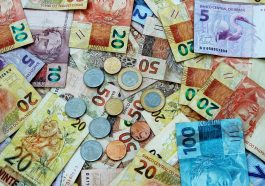 notas de dinheiro brasileiro espalhados, simbolizando o valor do auxílio emergencial 2021