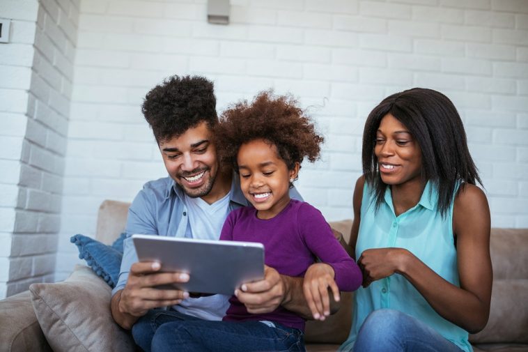 família afrodescendente mexendo no tablet
