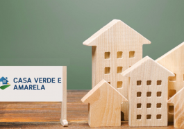 Um cartaz escrito programa casa verde e amarela e casas de madeira. Conceito de planejamento e financiamento imobiliário