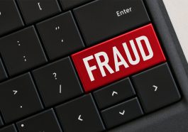 Teclado de computador com chave vermelha que diz FRAUDE, perigos on-line