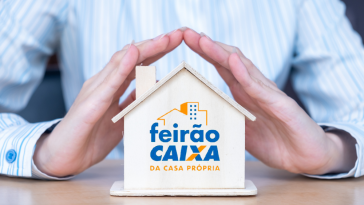 imagem de um homem de negócios apoiando a mão sob uma minuatura de casa com o logo do Feirão da Caixa de imóveis 2021